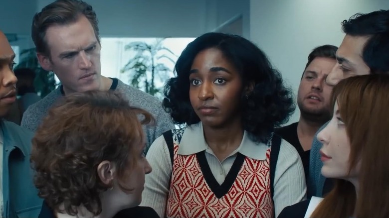 Ariel Ecton surrounded by her co-workers in "Opus" (2025)