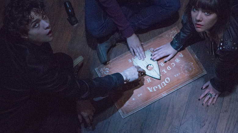A bunch of Ouija characters begin playing with the film's titular board in Ouija (2014)