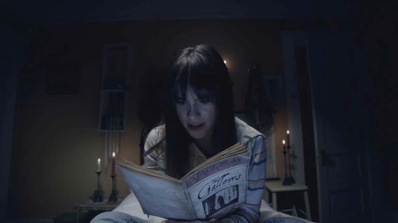 Auna Rae doing some important reading in The Gallows Act II (2019)