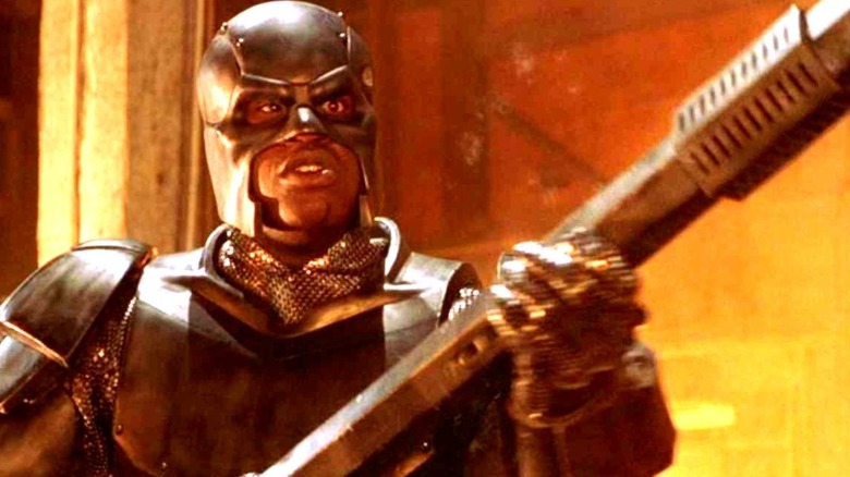 Steel standing in his mechanized with a weapon in hand in Steel (1997)