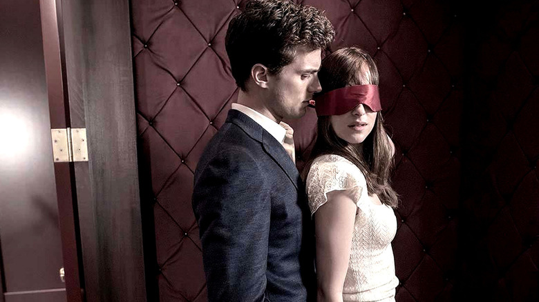 Christian Gray embraces a blindfolded Ana Steele in "Fifty Shades Darker" (2017)