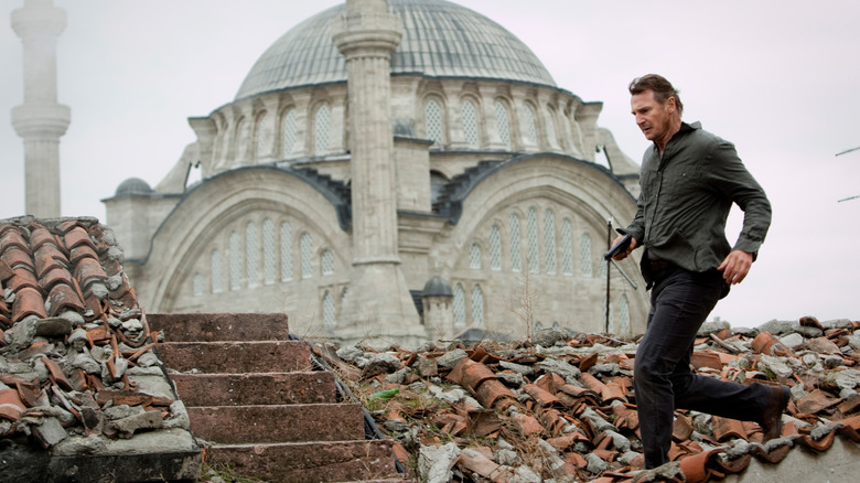 Bryan Mills runs through ruins in "Taken" (2012)