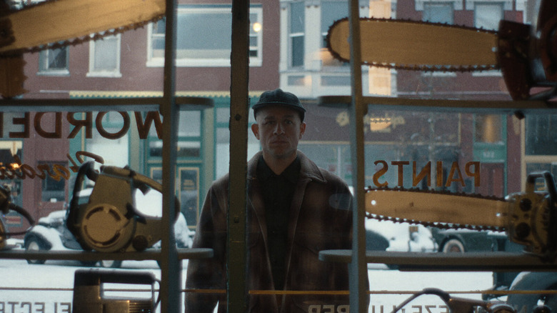 Ed Gein looking at chainsaws in a shop window on Monster: The Ed Gein Story