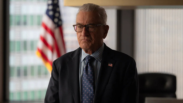 George wearing a flag pin scowling on Zero Day