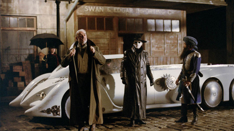Allan Quatermain, the invisible man, and Captain Nemo in front of a car in The League of Extraordinary Gentlemen (2003)