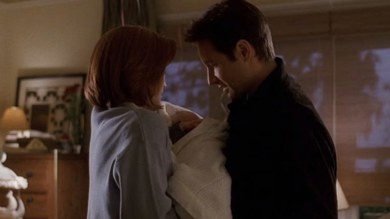 Dana Scully and Fox Mulder hold baby William on The X-Files (1993-2018)