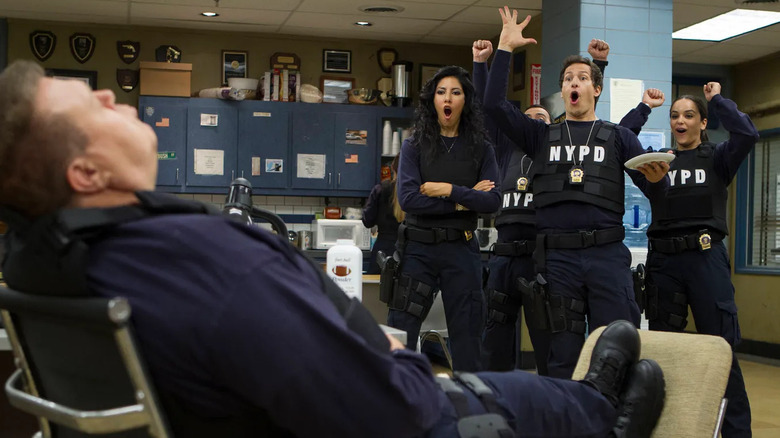 Detectives Diaz, Peralta, and Santiago throw chunks of food in their napping coworker's mouth on "Brooklyn Nine-Nine" (2013-2021)