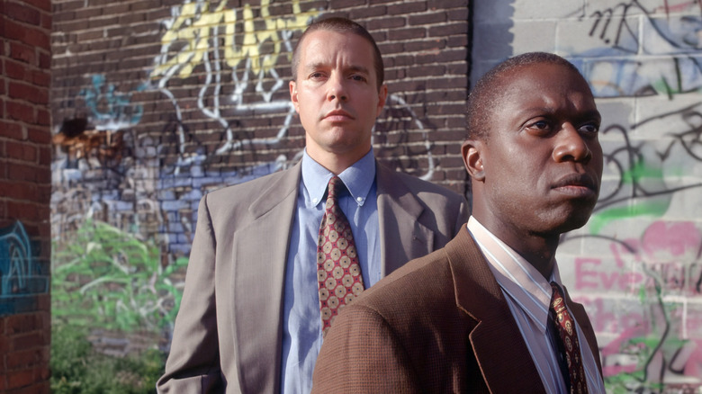 Detectives Tim Bayliss and Frank Pembleton stand in front of graffiti on "Homicide" (1993-1999)(