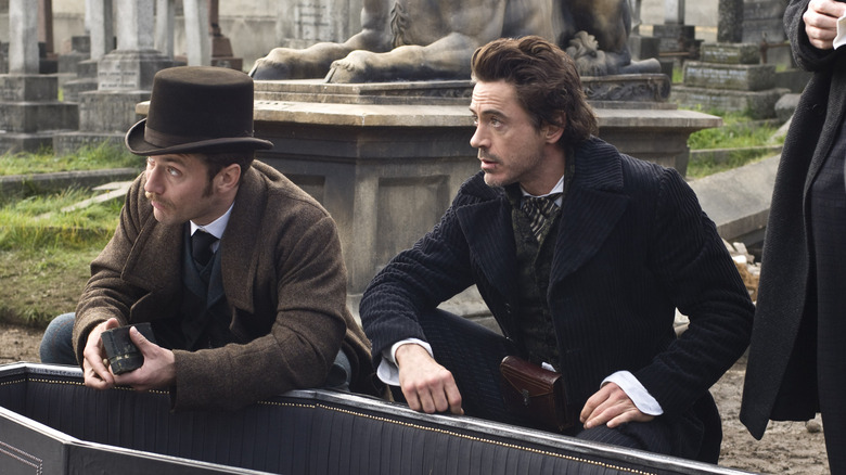Watson and Sherlock Holmes examine a tomb in Sherlock Holmes (2009)