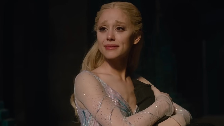 Glinda holding book and crying in "Wicked: For Good" (2025)