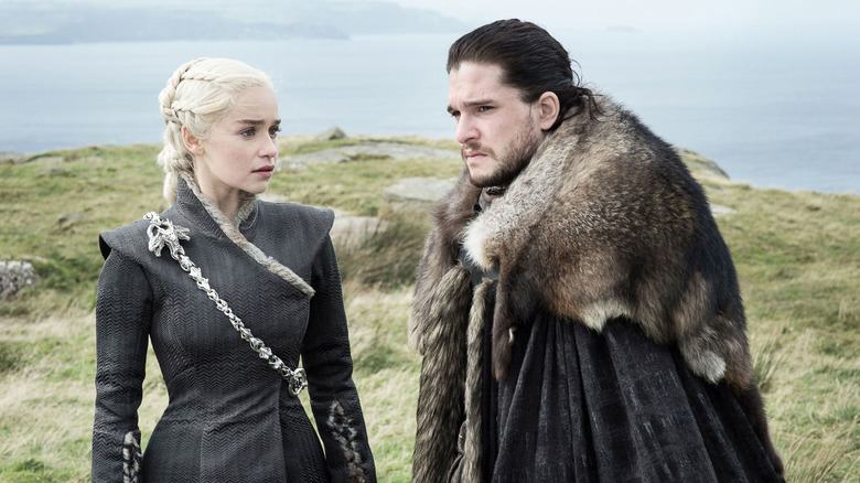 Emilia Clarke as Daenerys Targaryen stares at Kit Harrington as Jon Snow in Game of Thrones.