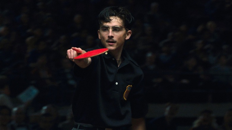 Marty Mauser pointing with ping pong paddle in Marty Supreme (2025)