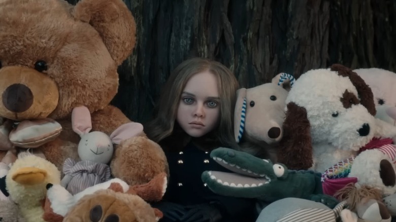 M3GAN's Megan sitting with stuffed animals