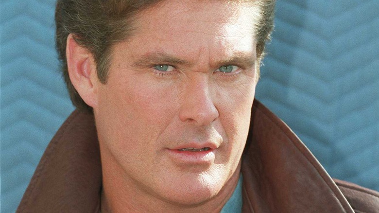David Hasselhoff in front of a blue backdrop