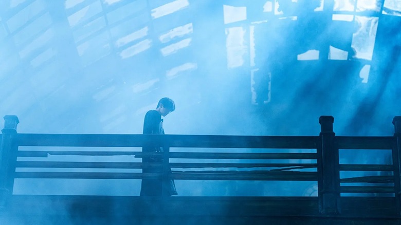 A shadowy figure lurking in the rafters in "Resurrection" (2025)