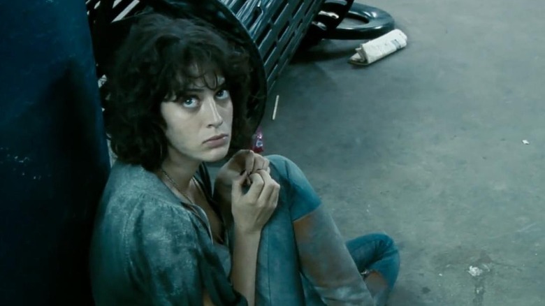 Marlena sitting on the floor of a subway station in Cloverfield (2008)