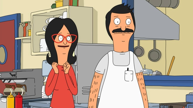 Linda smiles next to a stone-faced Bob in the restaurant in "Bob's Burgers"