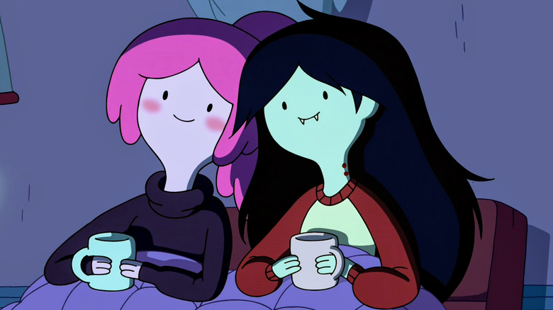 Princess Bubblegum and Marceline sit under blankets with mugs of coffee in 
