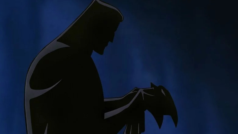 Bruce Wayne holds his Batman mask in the dark in Batman: Mask of the Phantasm (1993)