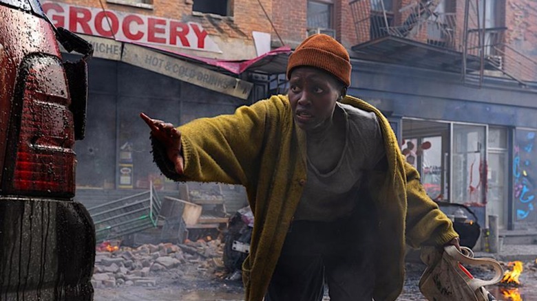 Sam creeps through wreckage in "A Quiet Place: Day One" (2024)