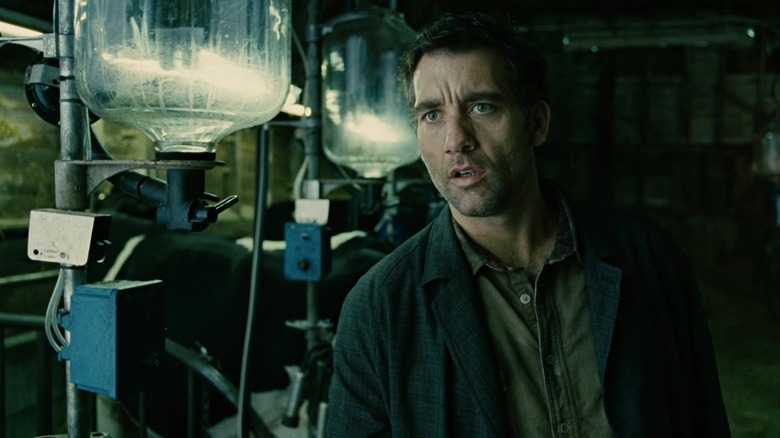 Theo stands in a cow pen in "Children of Men" (2006)