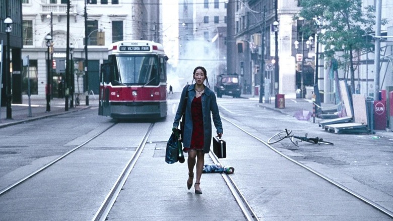 Sandra walking through abandoned street in "Last Night" (1998)