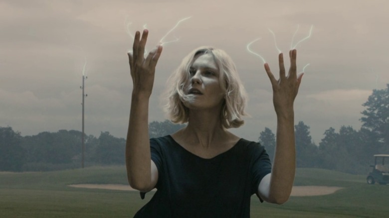Justine gapes at electricity shooting from her fingers in "Melancholia" (2011)