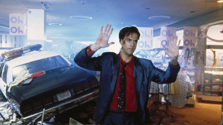 Harry stands in front of a crashed police car in "Miracle Mile" (1989)