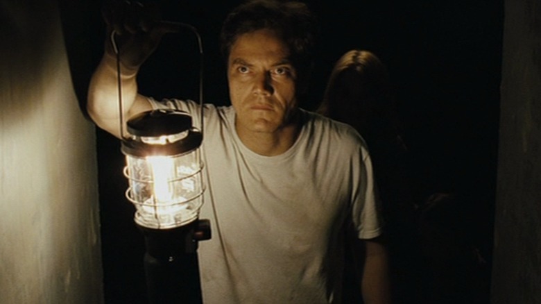 Curtis holds a lantern in a storm shelter in "Take Shelter" (2011)