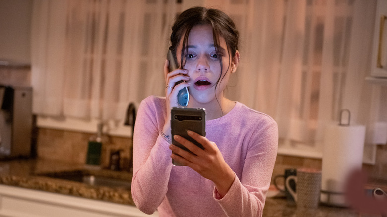 Tara staring at cell phone in horror in Scream