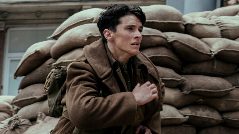 Tommy racing for his life in "Dunkirk" (2017)