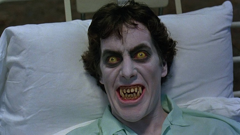 David displays wolfish teeth and yellow eyes while in bed
