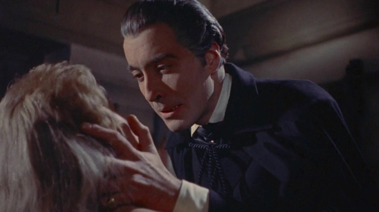 Dracula holds Mina Holmwood's head in his hands