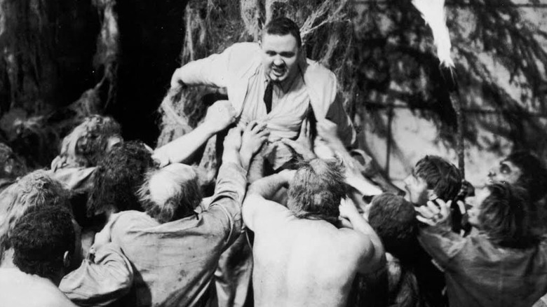 The beast-men reach for Dr. Moreau