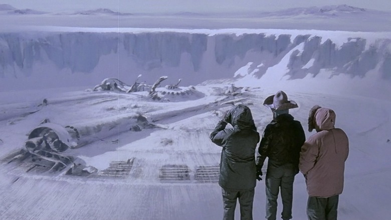 Macready, Norris, and Copper observe the Thing's buried spacecraft