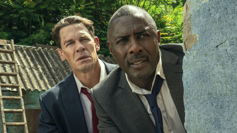 Derringer and Clarke peek out from behind a wall in 