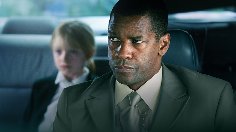 Creasy looks at Pita in the backseat in "Man on Fire" (2004)
