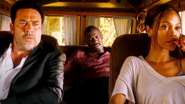 Captain Franklin Clay (Jeffrey Dean Morgan), Captain William Roque (Idris Elba), and Aisha (Zoe Saldaña) waiting in a van