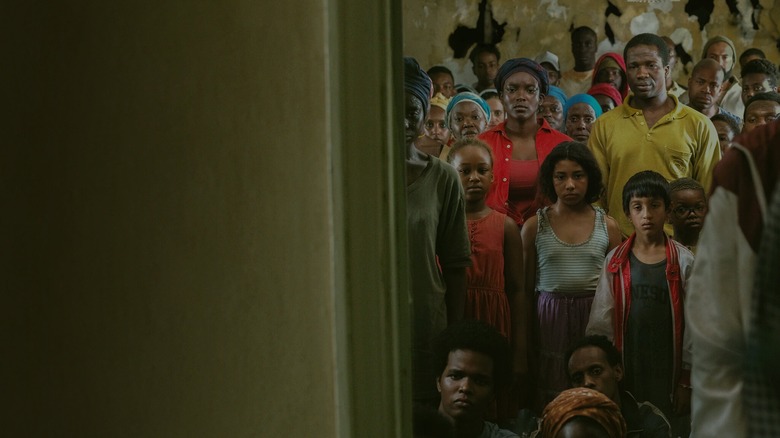 RIal and Bol standing with figures from the past in "His House" (2020)