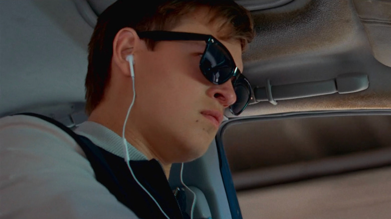 Baby drives while wearing earphones in "Baby Driver" (2017)