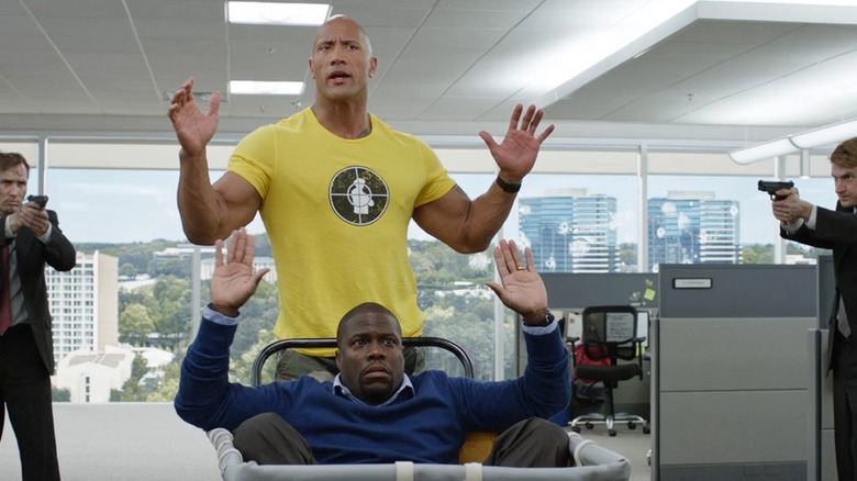 Bob and Calvin hold their hands up for the CIA in "Central Intelligence" (2016)
