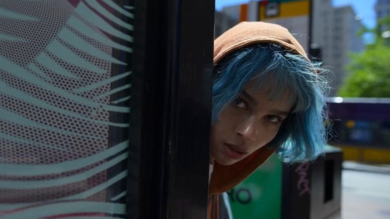 Angela peers from behind a sign in "Kimi" (2022)