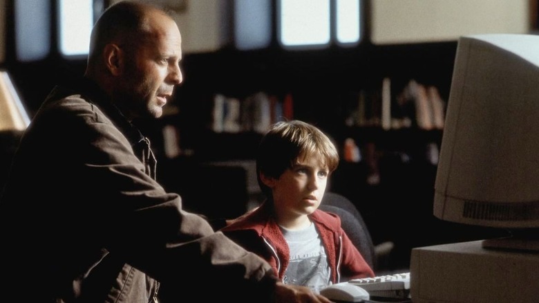 Art Jeffries and Simon look at a computer in "Mercury Rising" (1998)