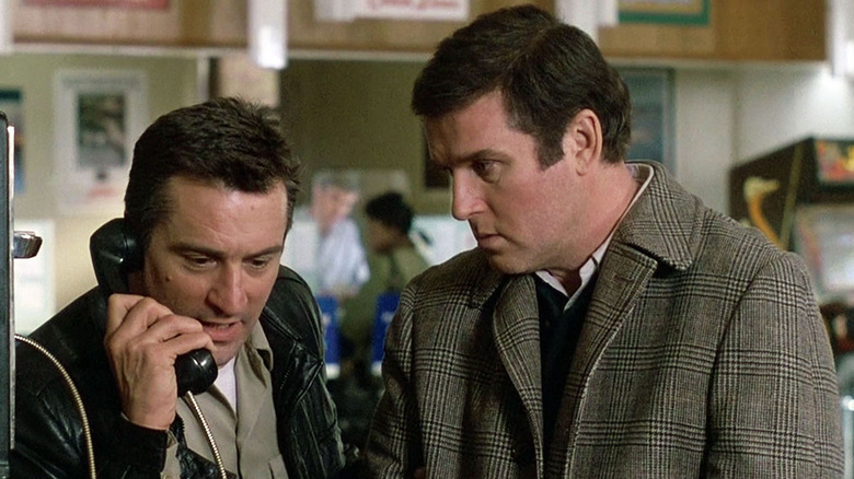Jack Walsh on the phone with Jonathan Mardukas standing by him in "Midnight Run" (1988)