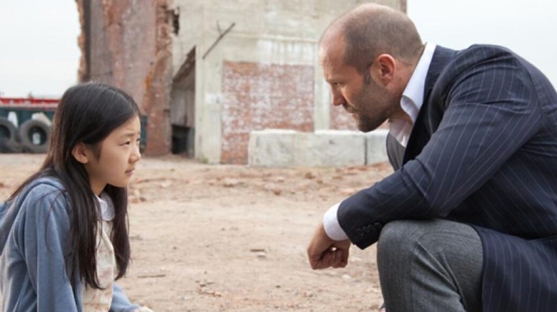 Luke and Mei talk in an empty lot in "Safe" (2012)