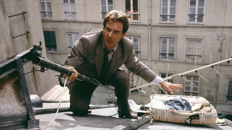 Walker climbs a roof to chase a suspect in Frantic (1988)