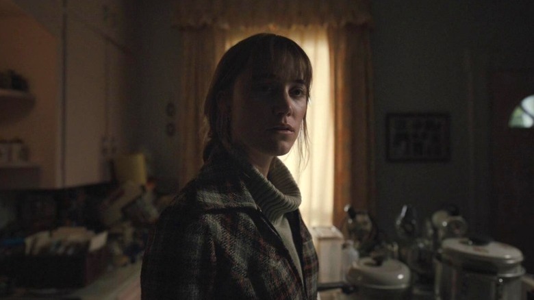 Lee Harker standing in a dark kitchen in Longlegs