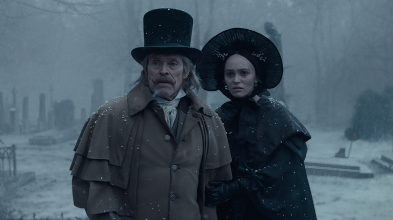 Franz and Ellen stand in a wintery graveyard in Nosferatu