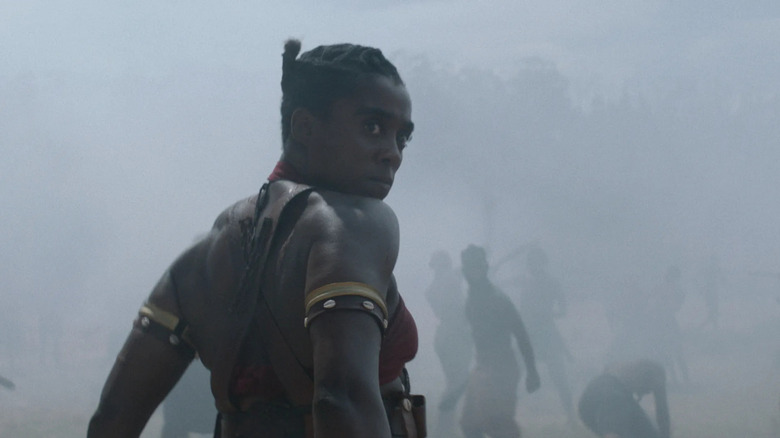 Izogie looks over her shoulder in The Woman King