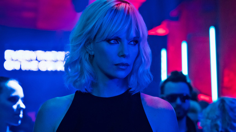 Lorraine bathed in blue light in a nightclub in "Atomic Blonde" (2017)